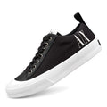 Zapatillas Armani Exchange negras con suela blanca, vista lateral